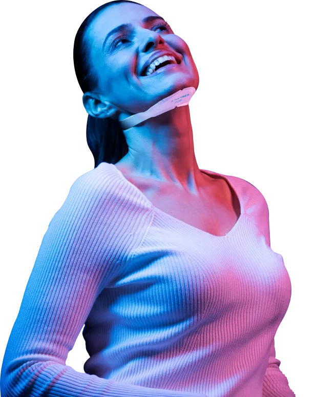 EMface facial toning London - woman smiling with a facial applicator under her chin Woman smiling with a facial applicator under her chin at our Harley Street clinic, EMface facial toning London